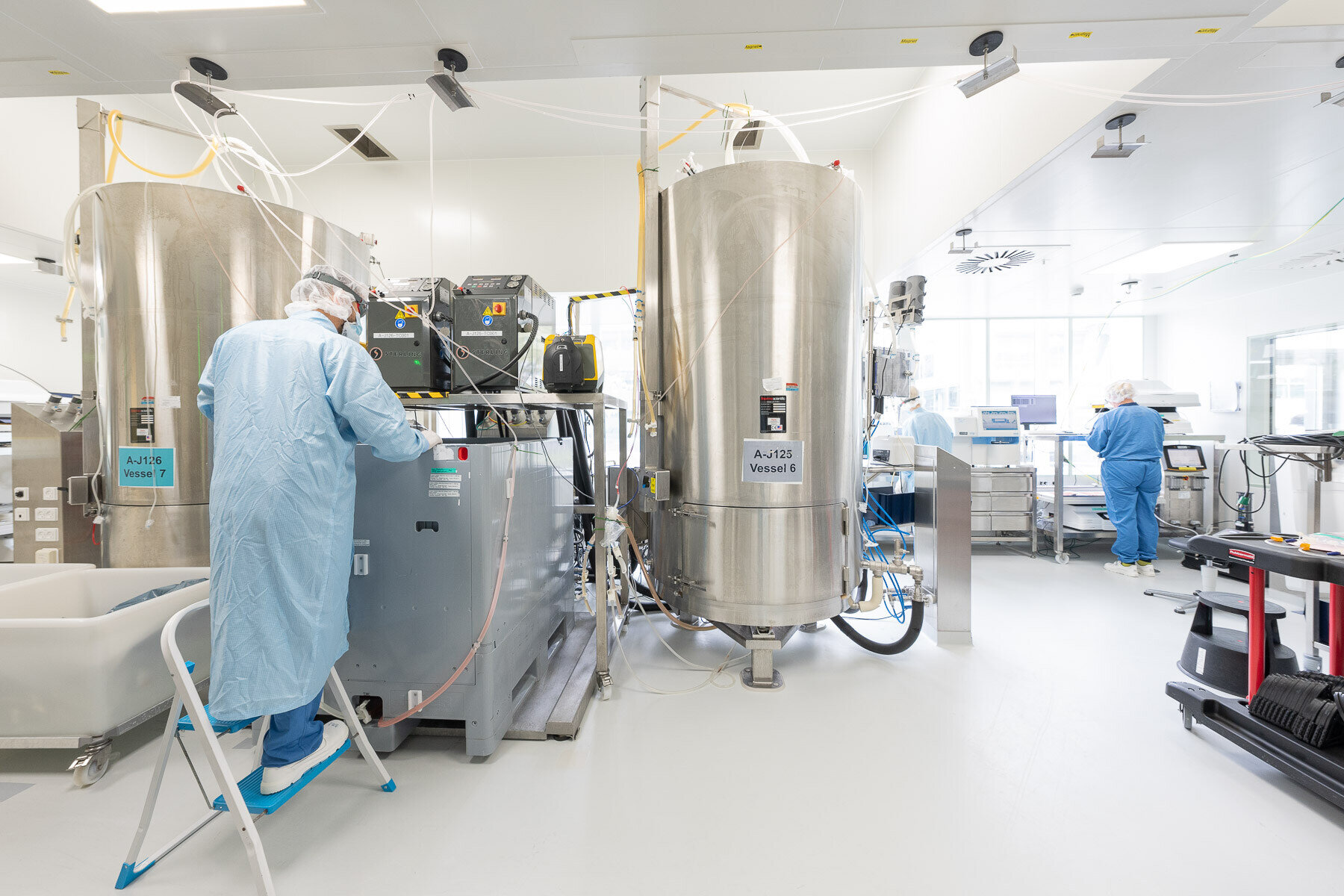 scientist in room with bioreactor