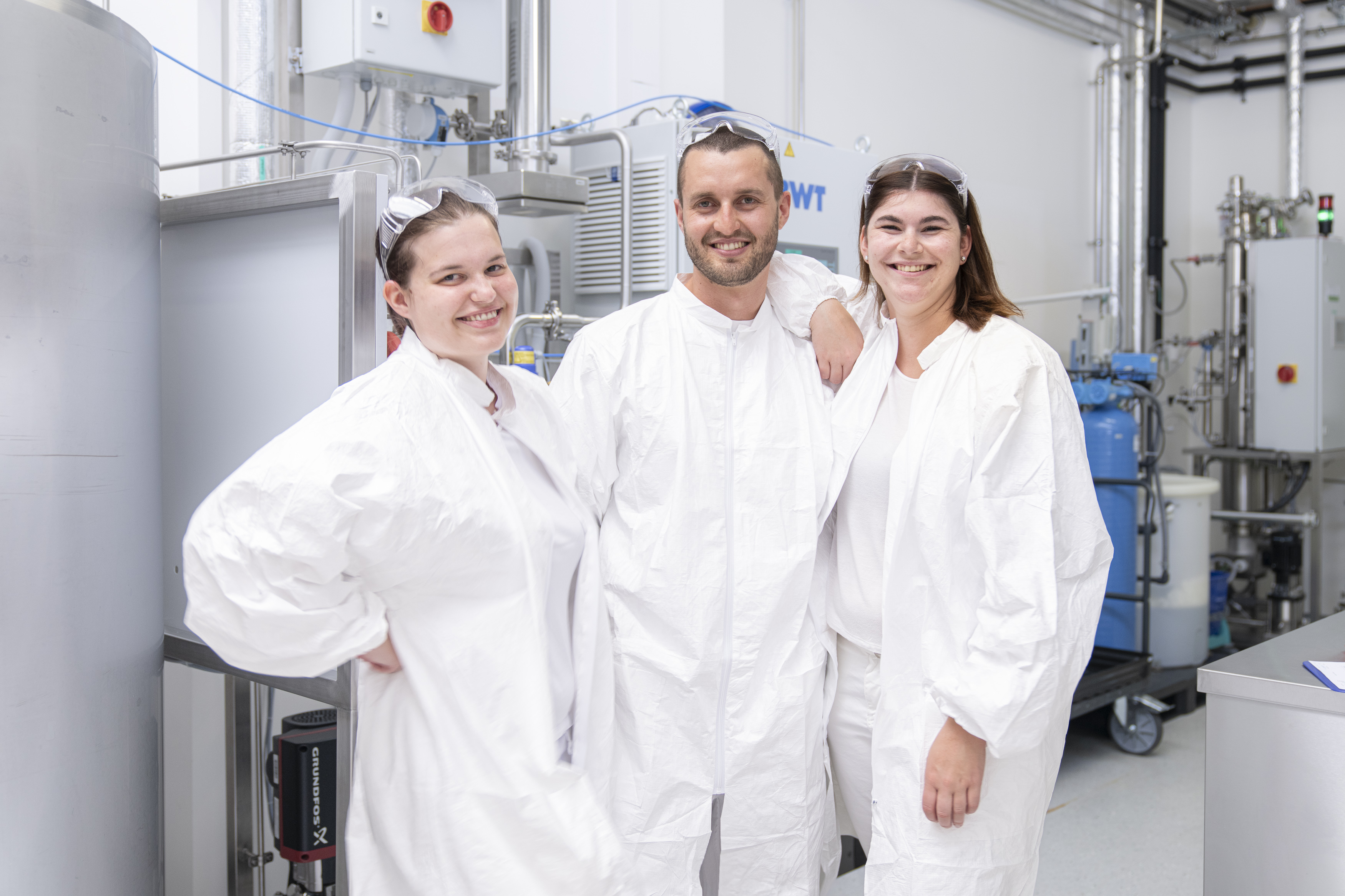 AGC Biologics team of scientists smiling in laboratory.