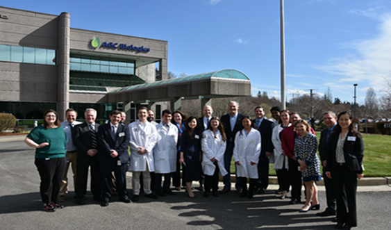 Governor Inslee with group of team members from AGC Bio in front of HQ building