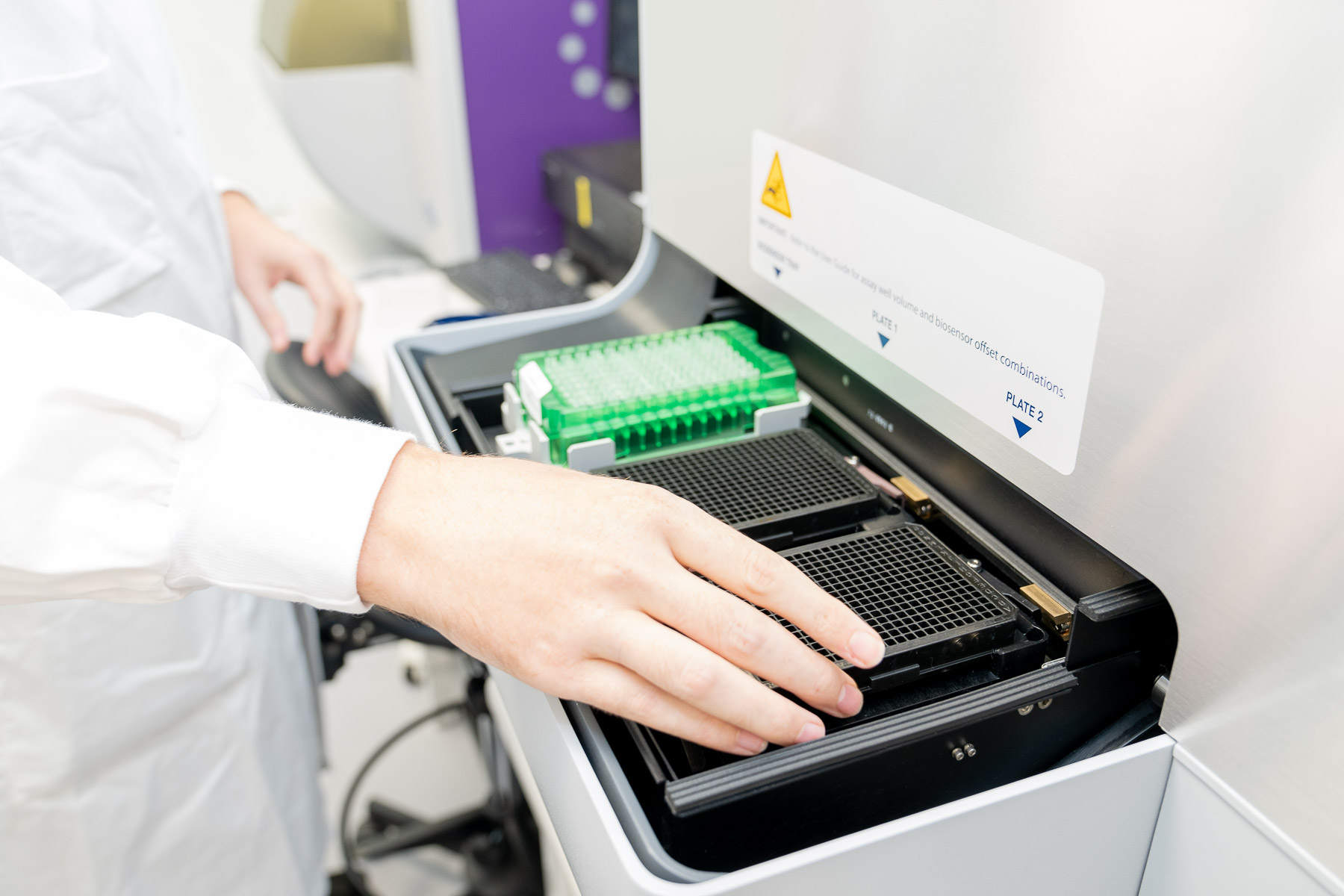 Lab technician using biotech equipment.